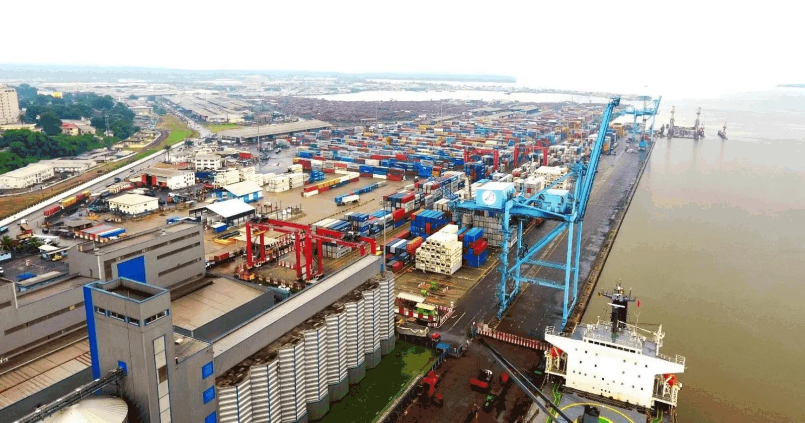 Aerial view of the Douala container terminal: quay cranes, container yard and the Wouri